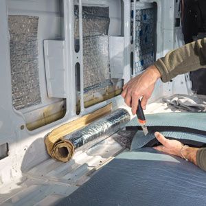 man cutting camper van fabric